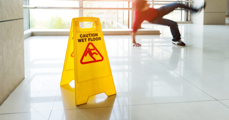 Man slips falling on wet floor
