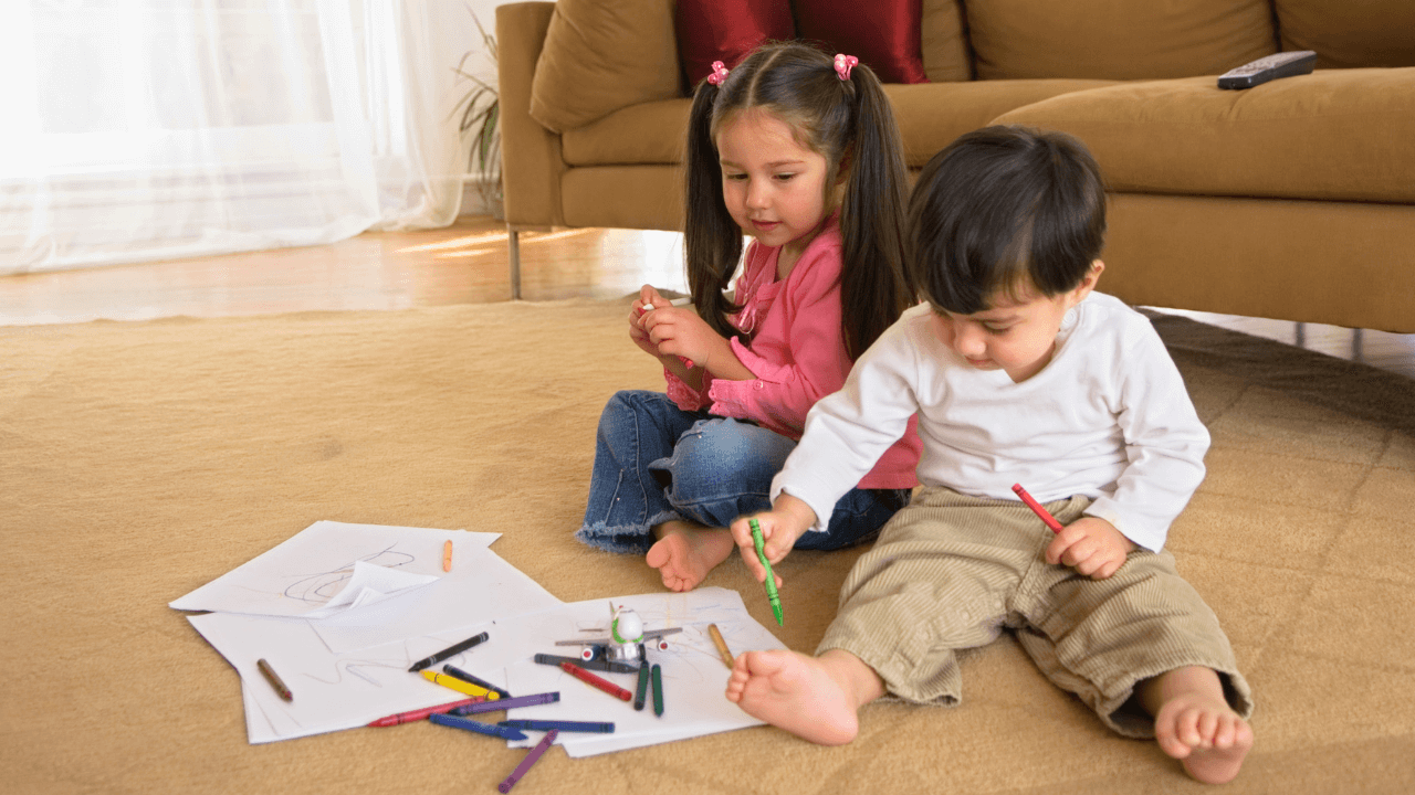 Children coloring on the floor.