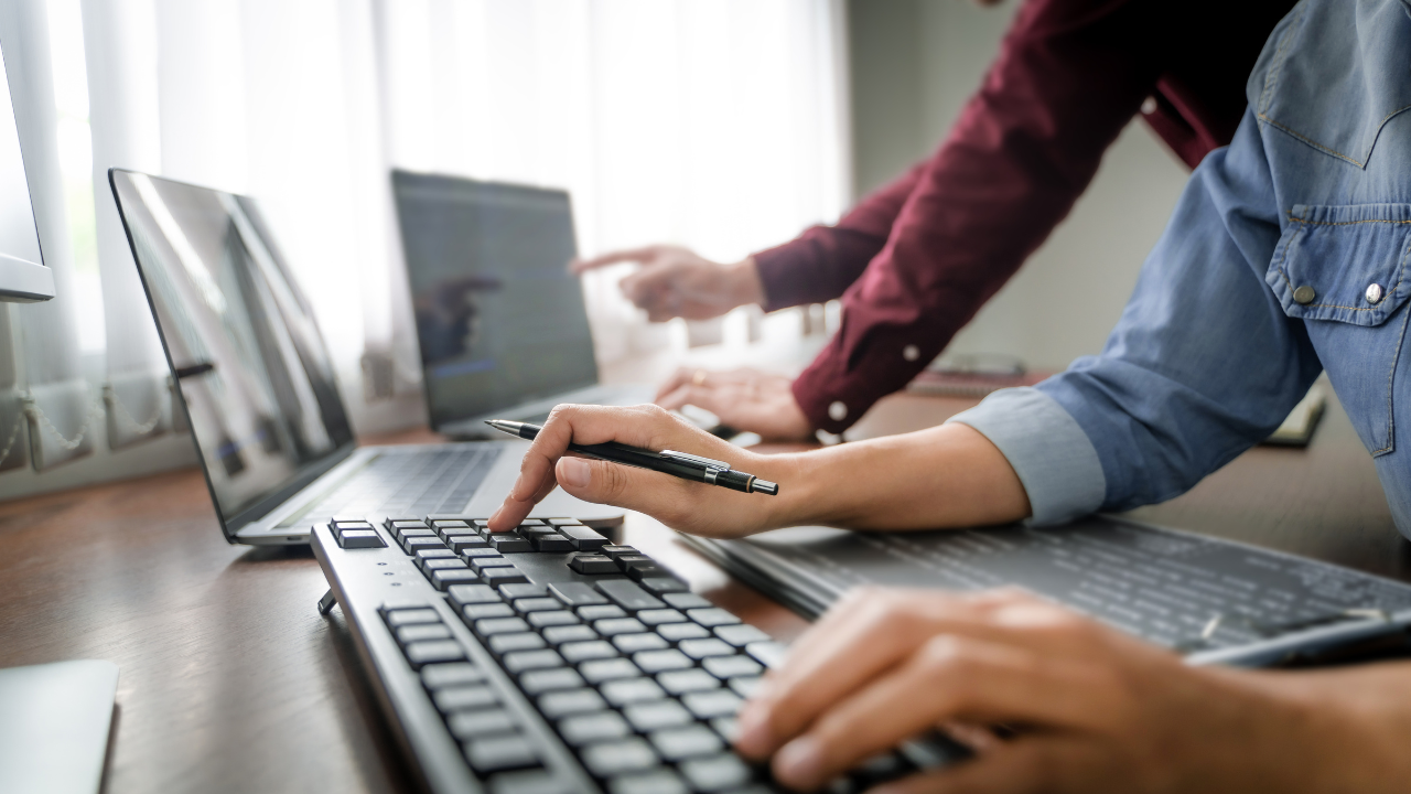 Two people using the computer