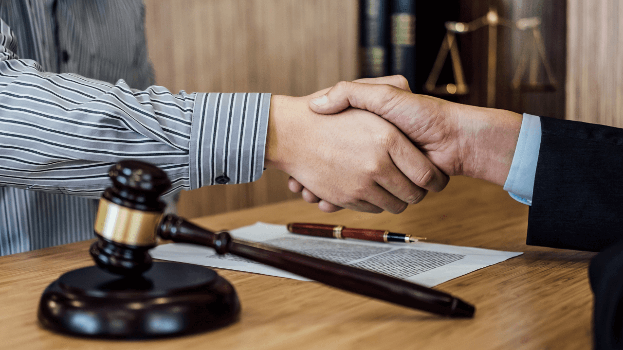 A lawyer and a client shaking hands.