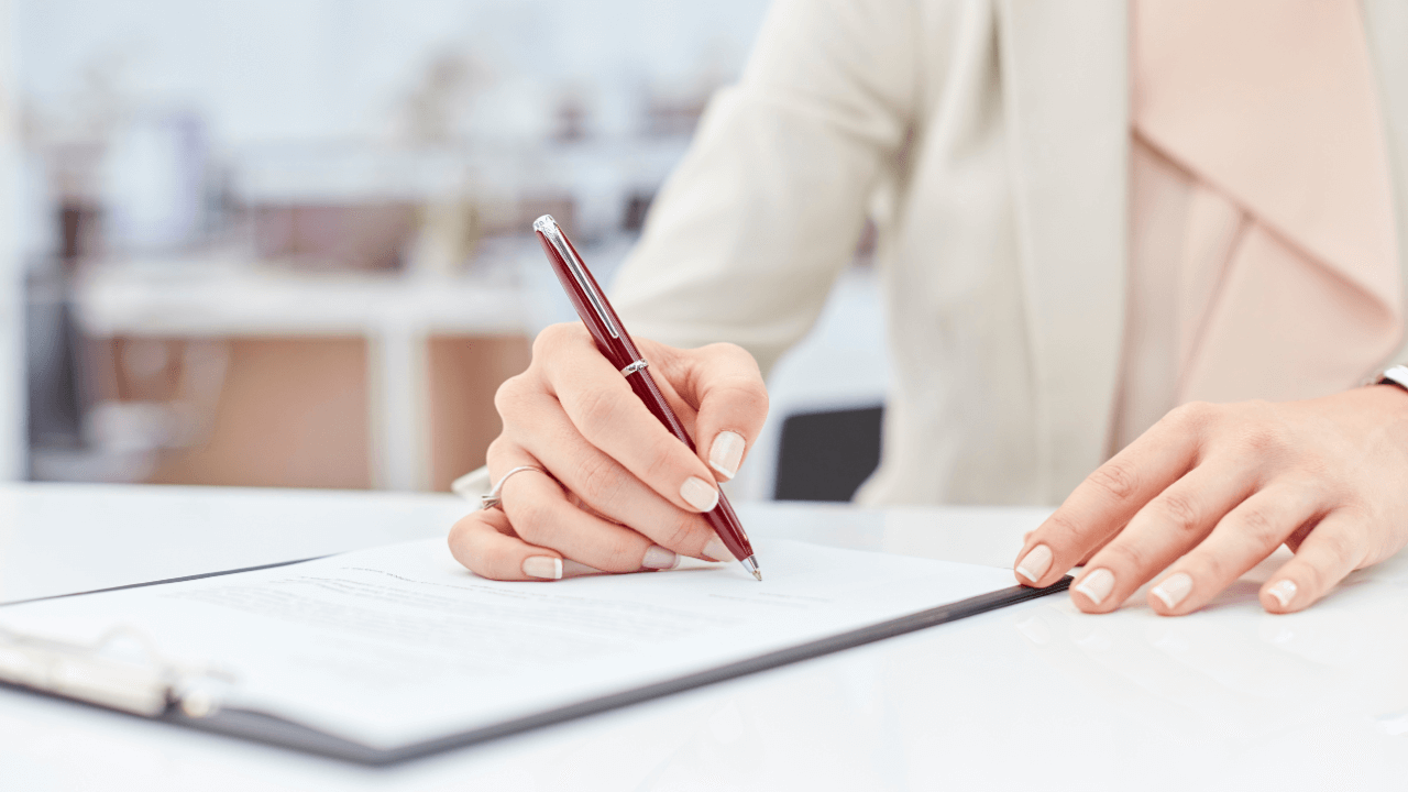 A person signing documents.