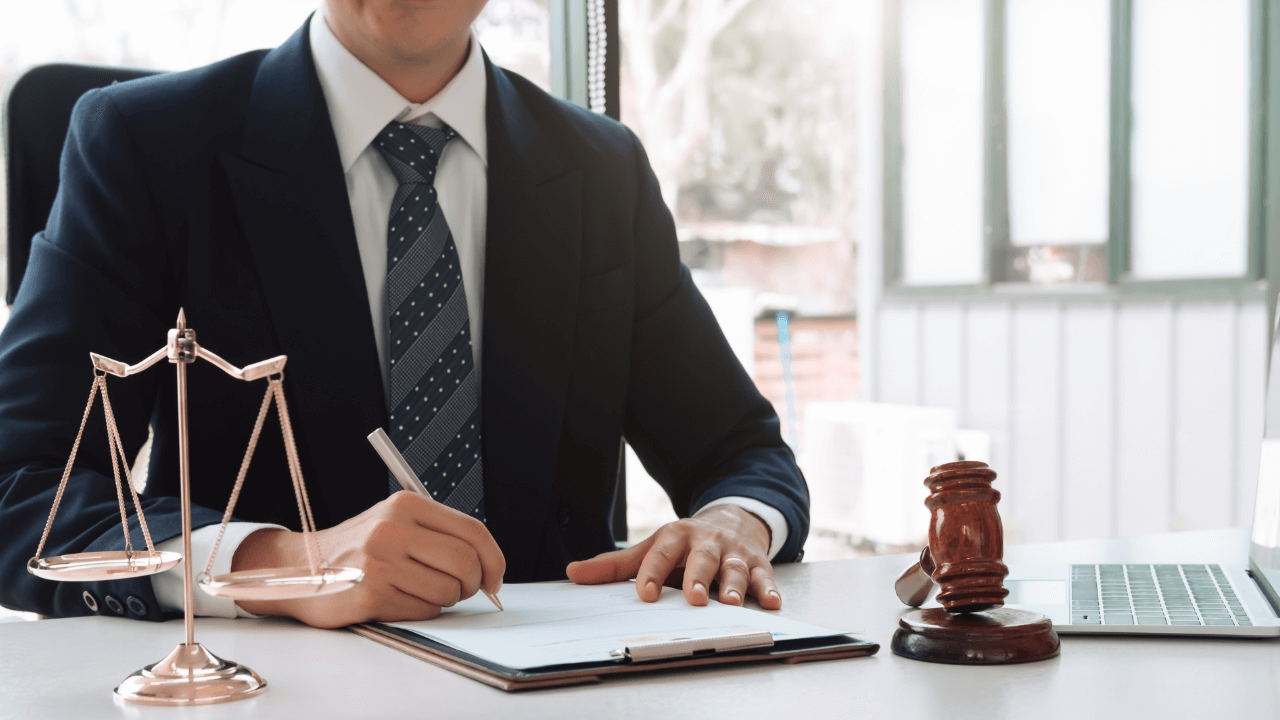 An attorney signing several documents.