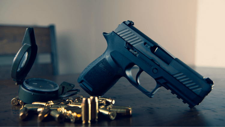 A handgun with bullets on the table.