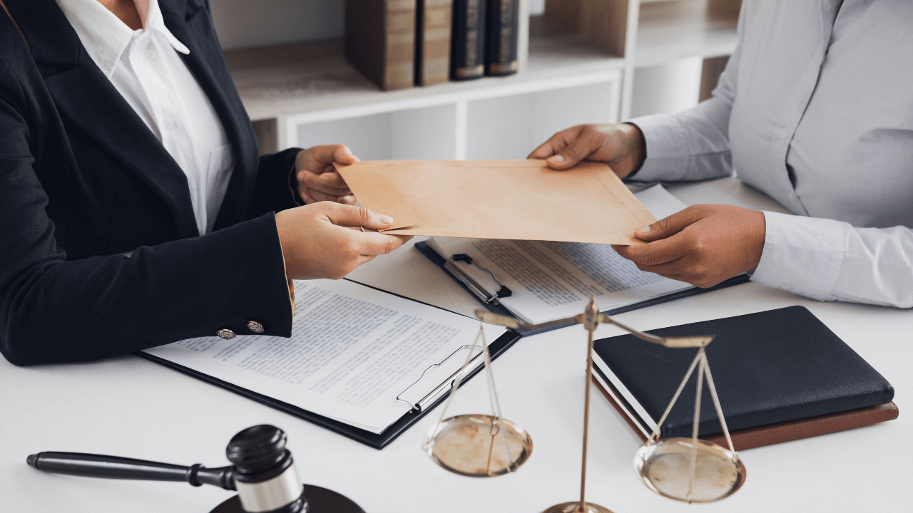 A lawyer handing her clients her restraining order copy.