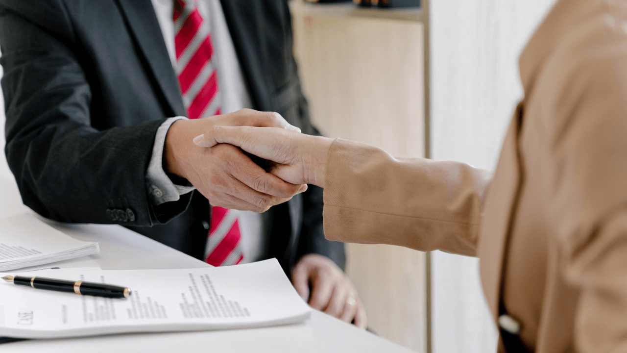 An estate planning attorney shaking hands with his client.