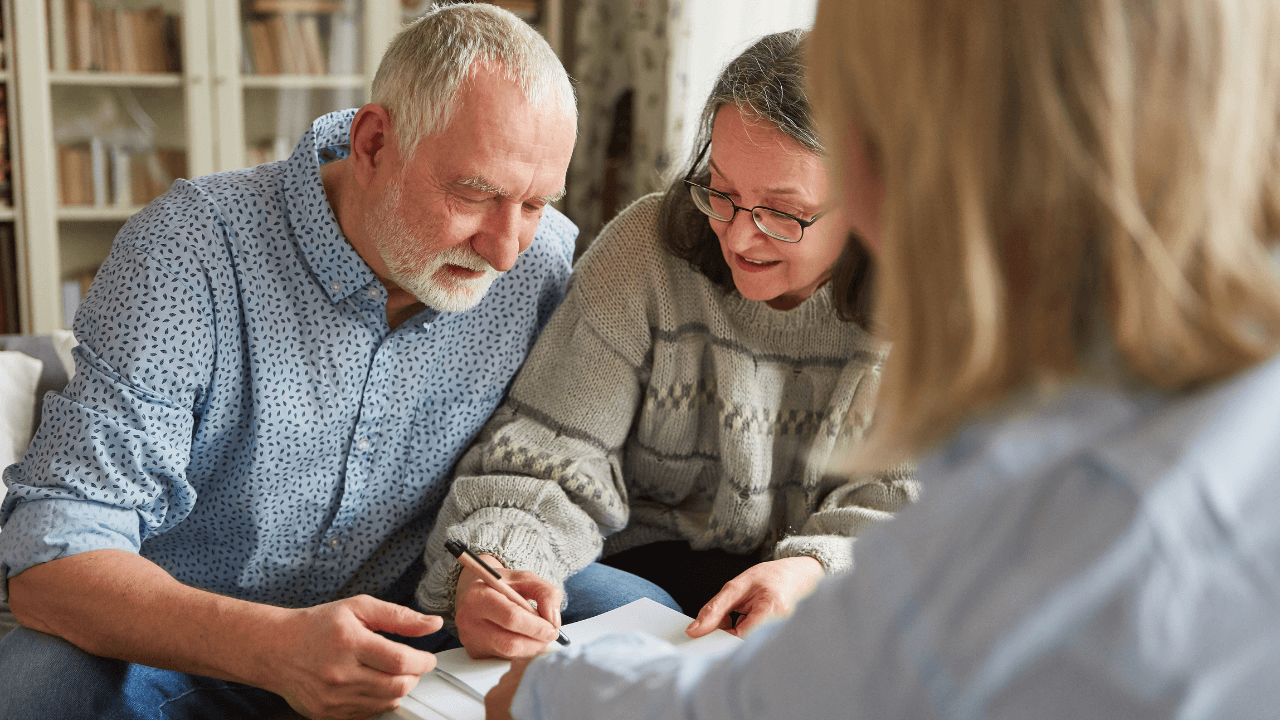 A couple signing their estate planning documents.