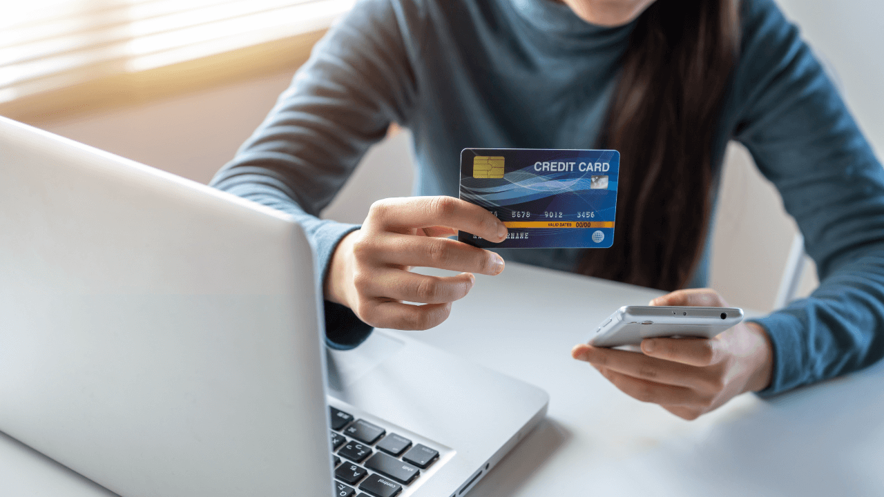 A woman looking at her credit card and online banking accounts.