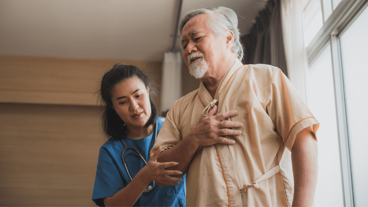 An elderly person suffering from a stroke being assisted by a healthcare professional.