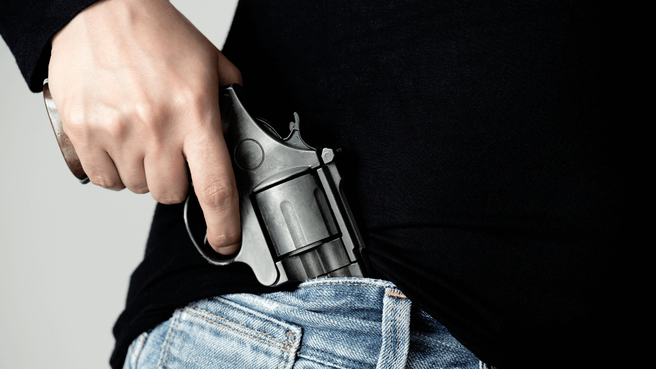 A person holding a handgun.