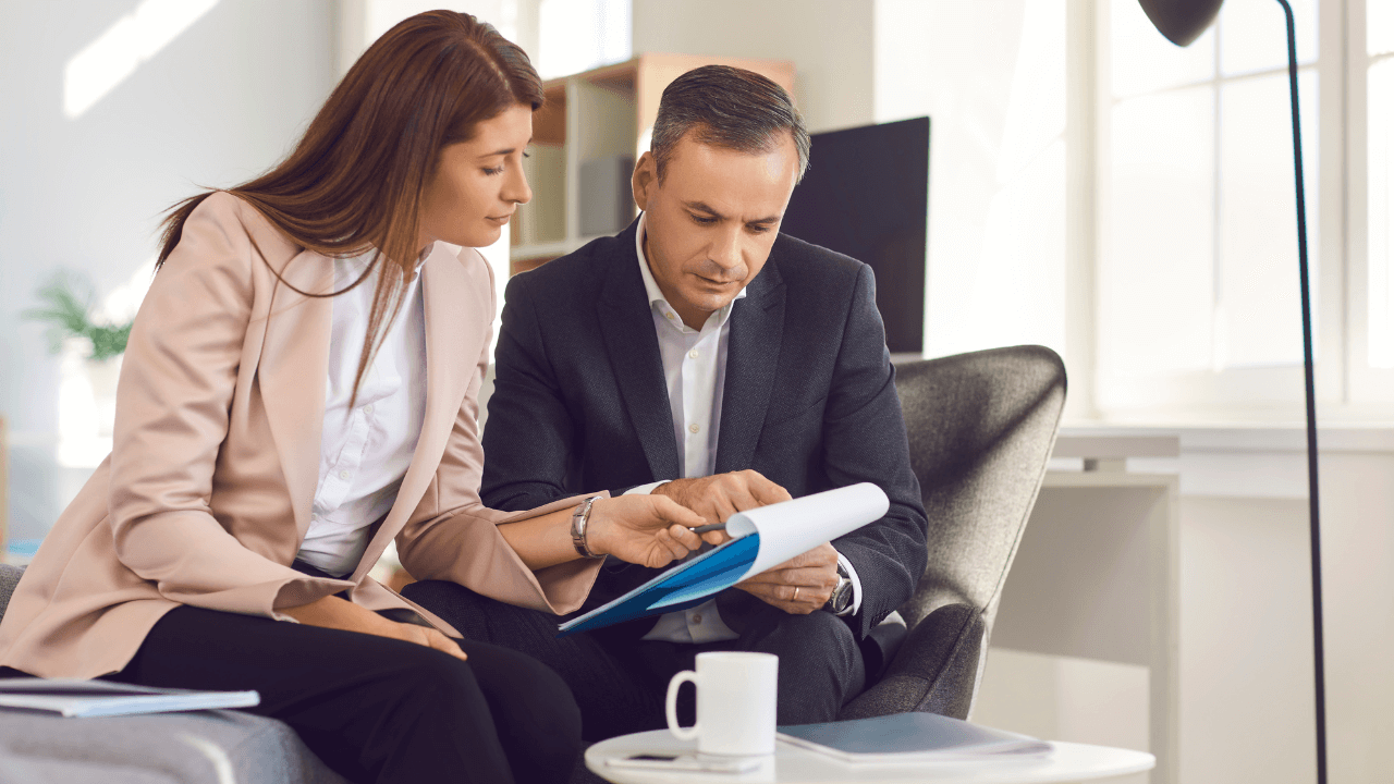 A man and a woman discussing business plans together.