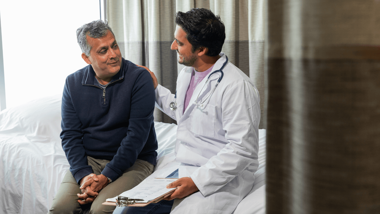 A photo of a man having a consultation with a physician.