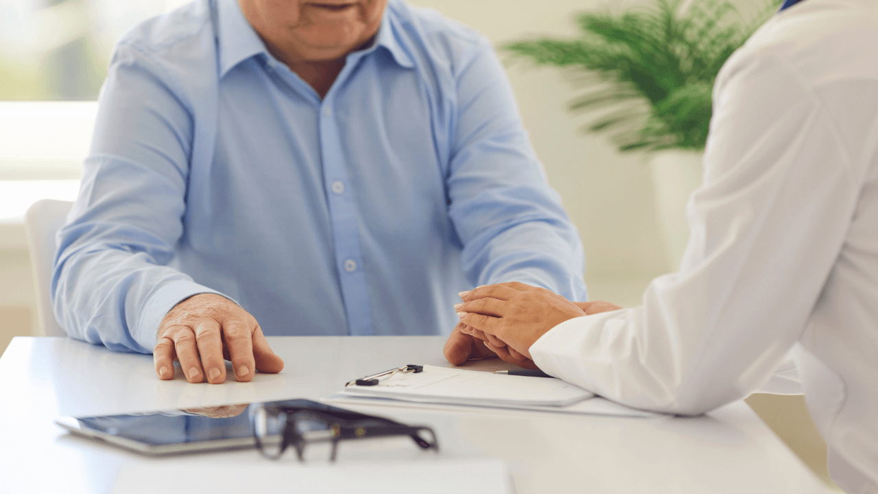 An old man talking to his healthcare provider.